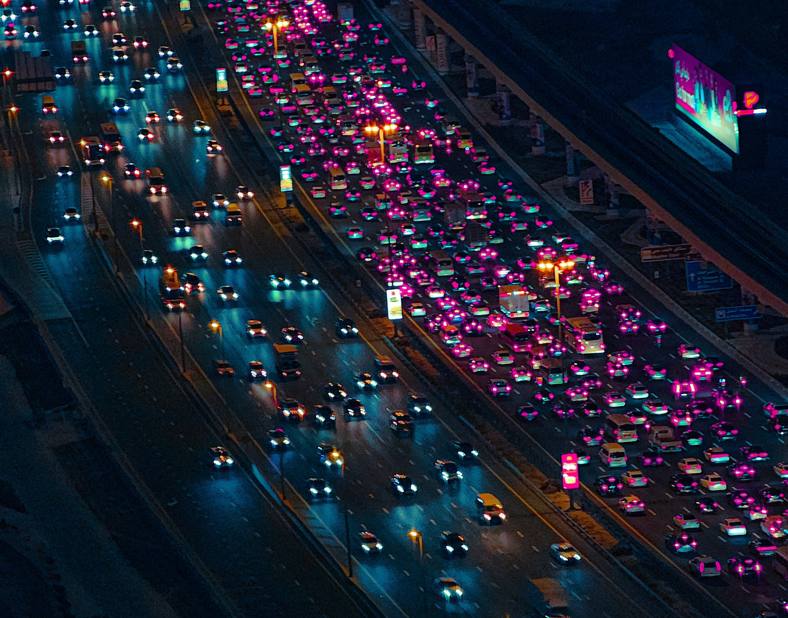 A busy highway with a lot of traffic at night.