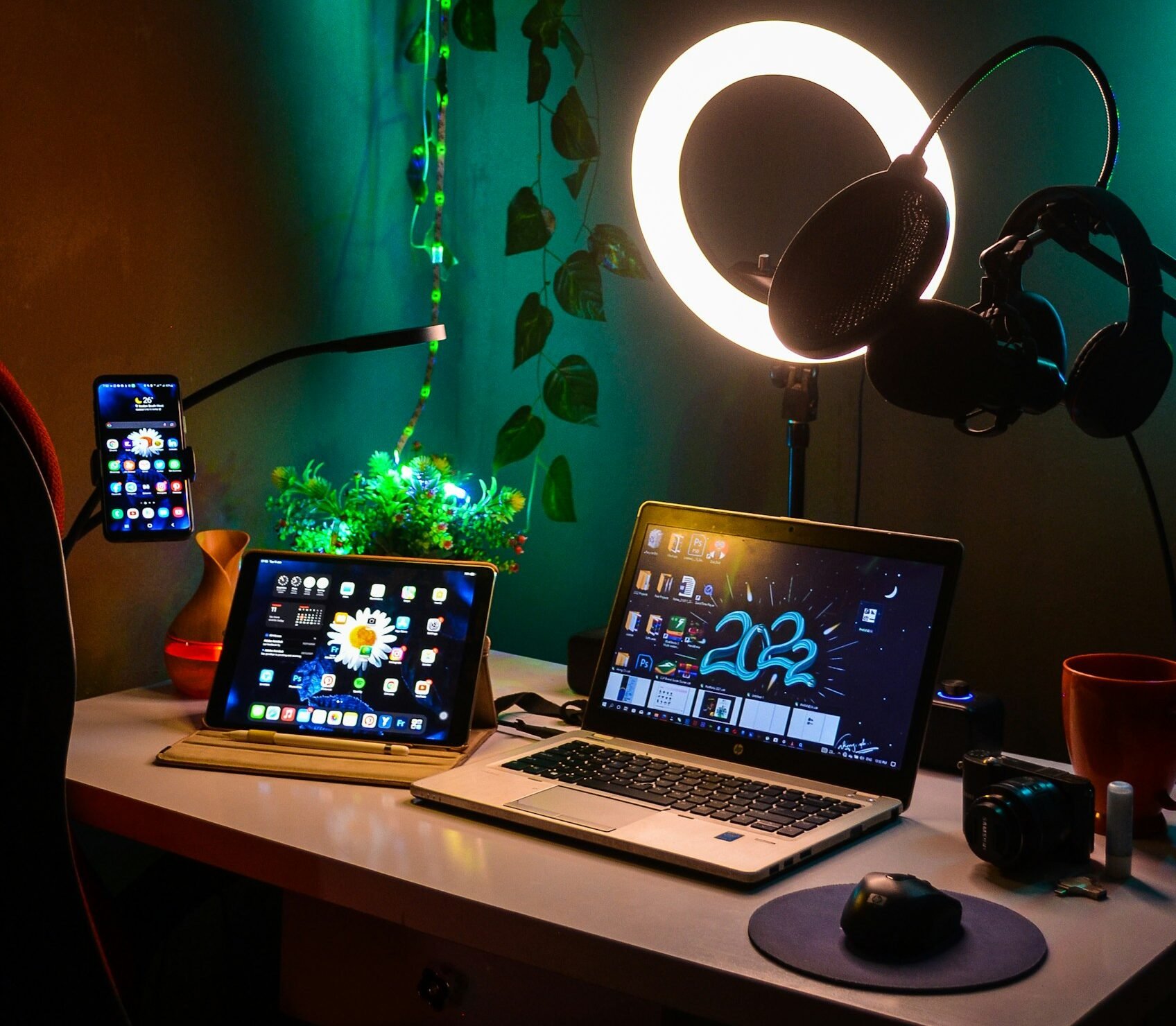 Table at home with a smartphone, laptop, tablet, wireless headphones, etc.