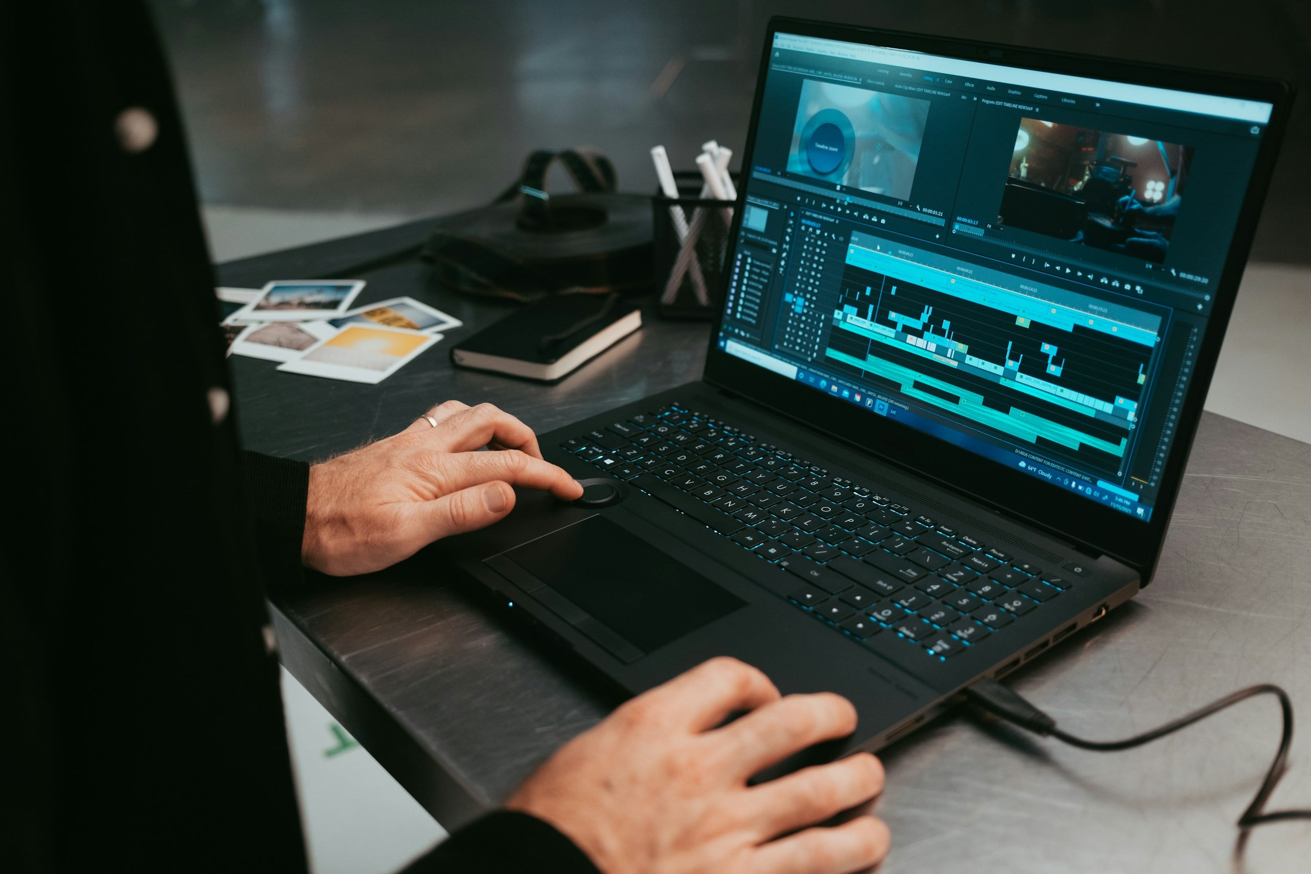Person editing video on a laptop.