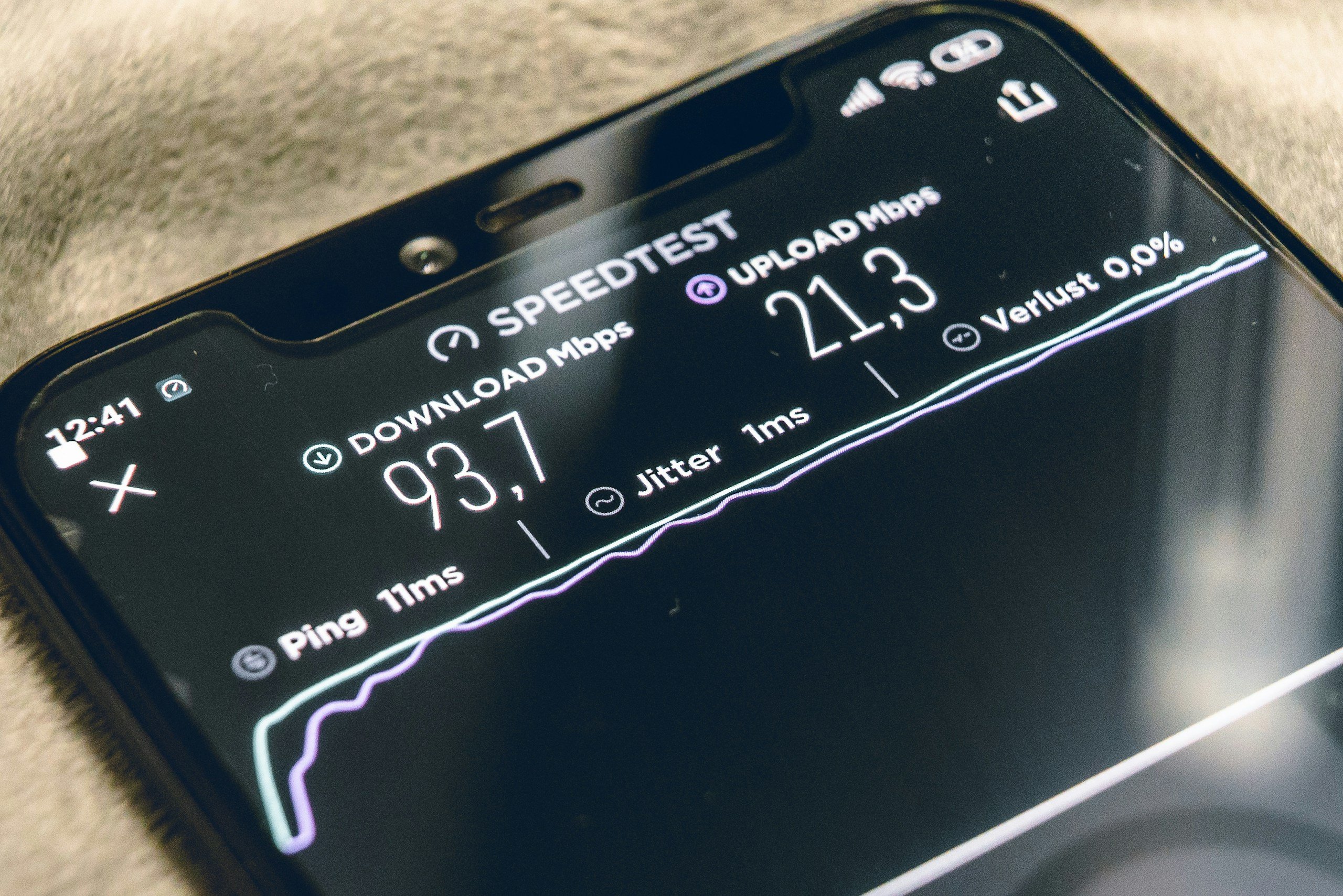 Black smartphone running an internet speed test.