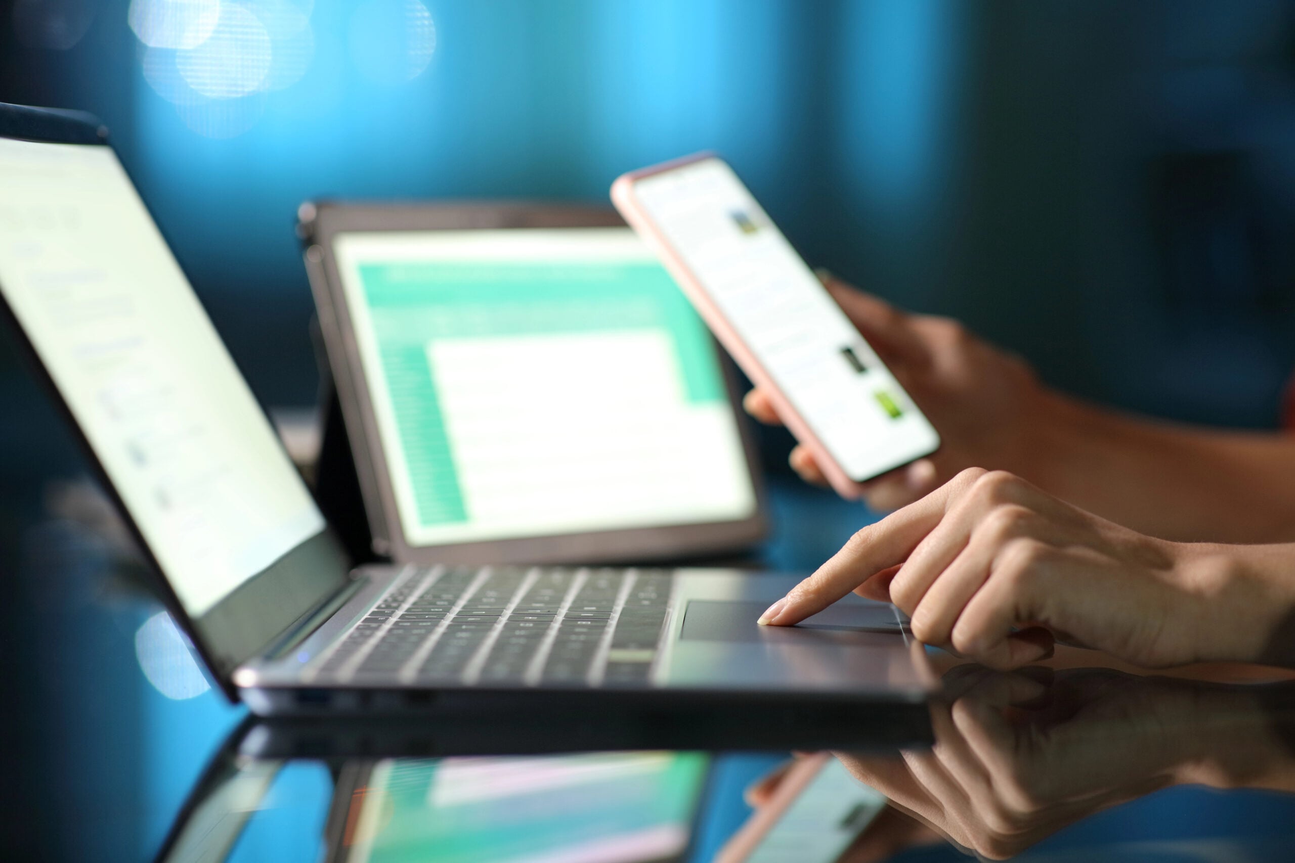 Close up portrait of a woman hand using multiple devices in the night at home