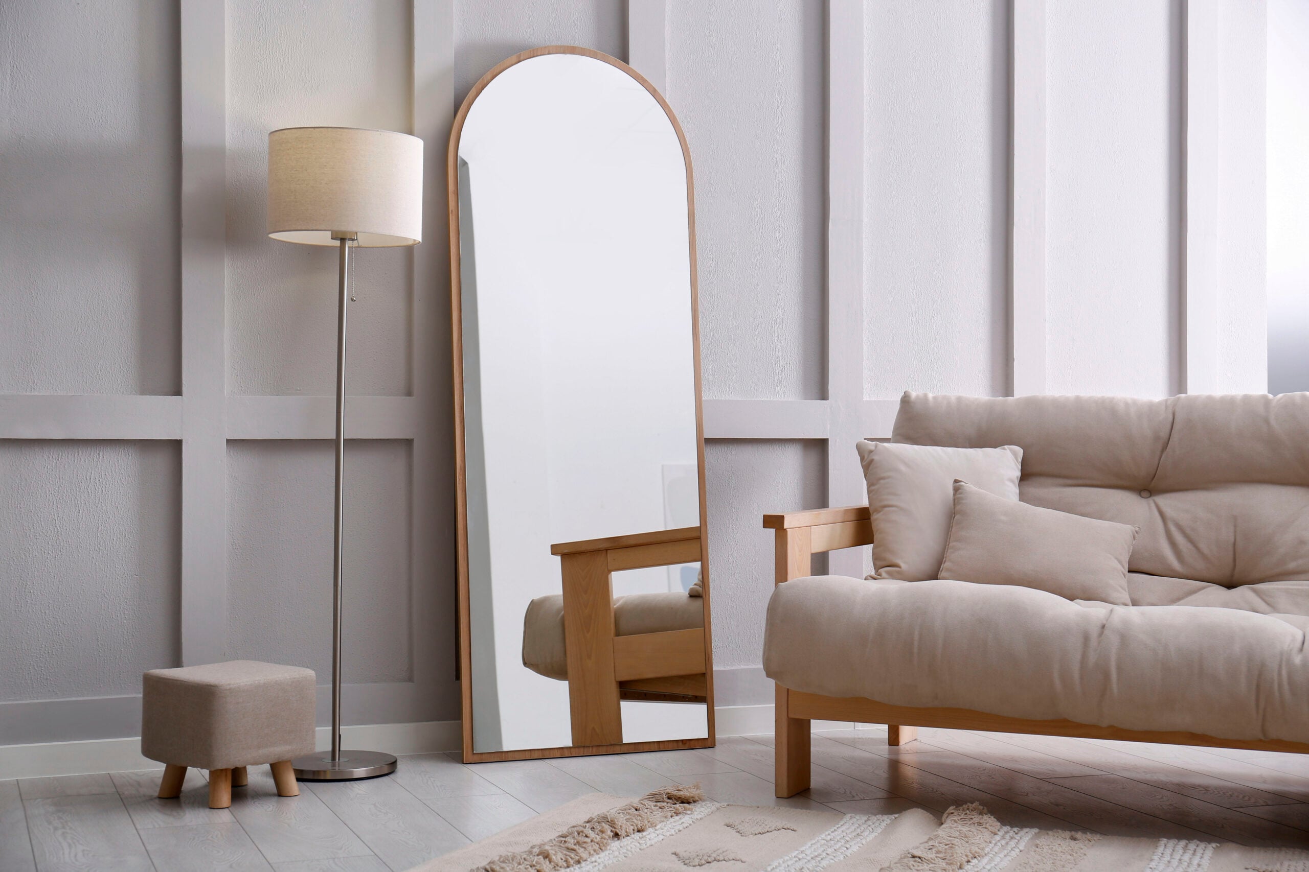 Light room interior with large mirror near wall