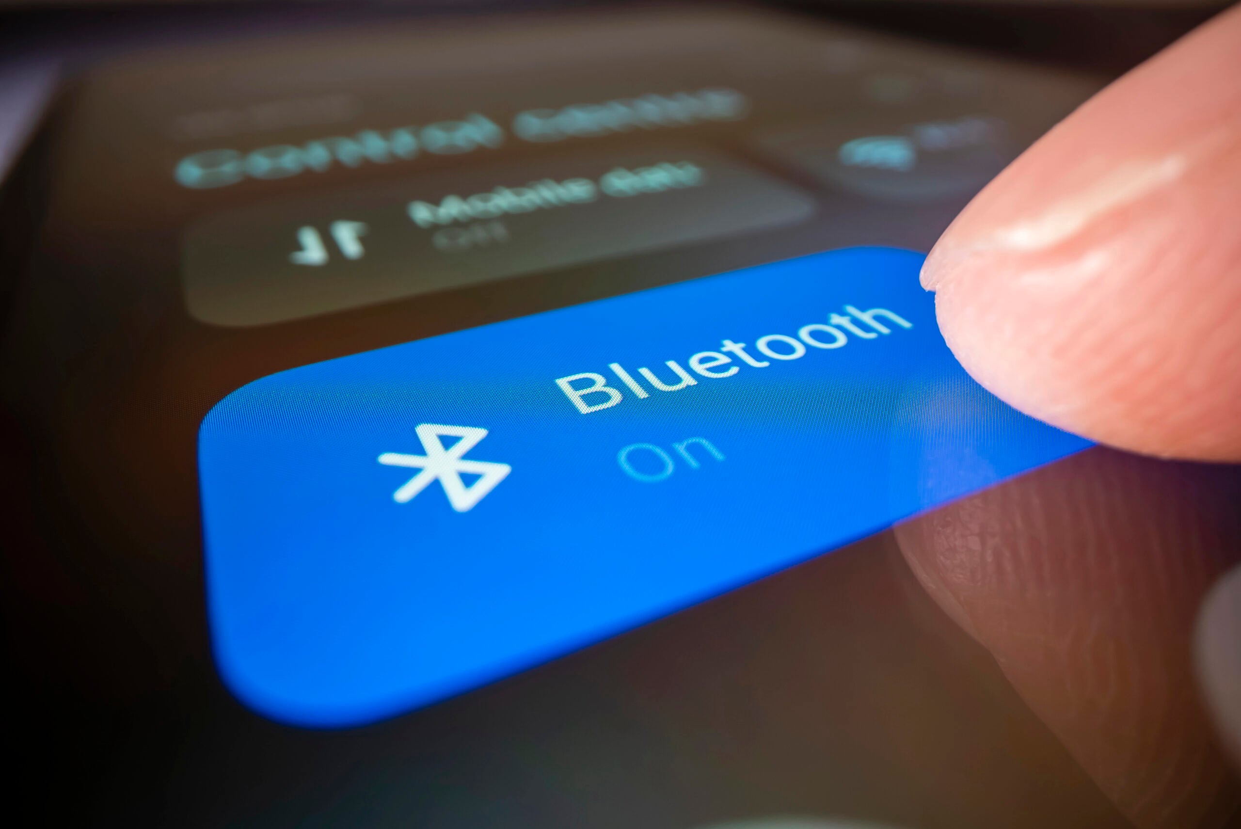 Melbourne, Australia - Oct 3, 2022: Close-up view of turning on Bluetooth on a smartphone, shot with macro probe lens