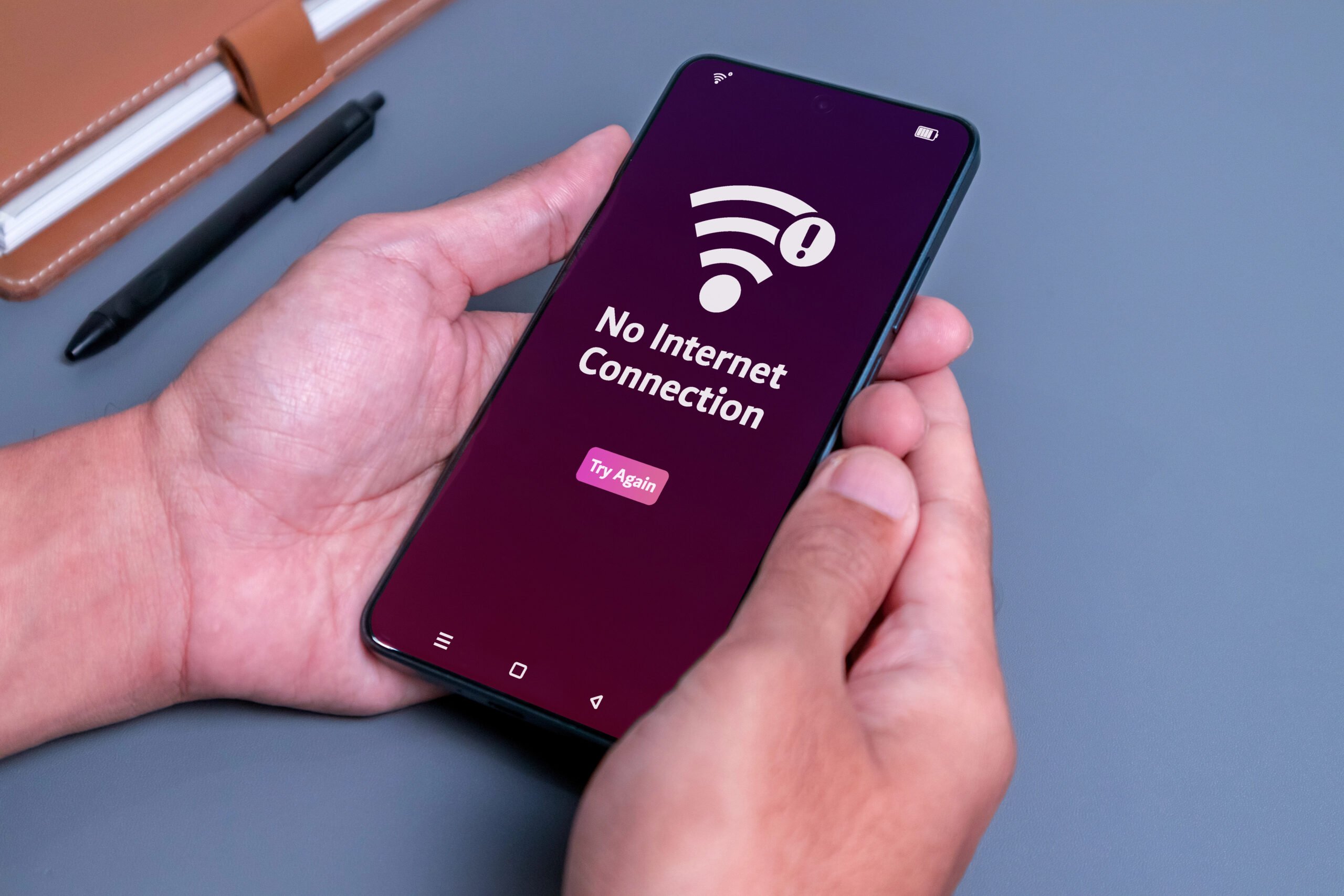 No internet access or bad connection concept. Man using smartphone with notification no internet connection.