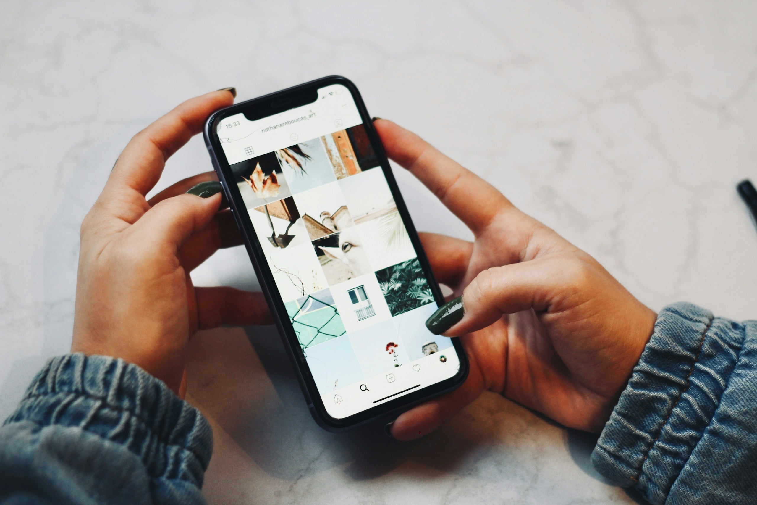 Person looking at photo gallery on cell phone.