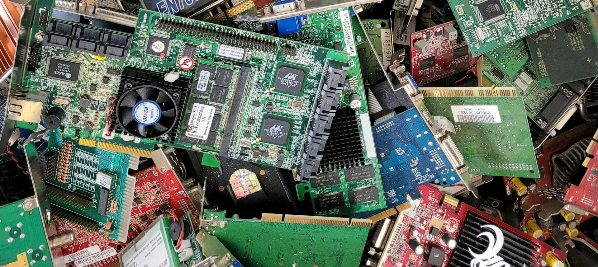 Stack of graphics cards and motherboards in a landfill site, Germany