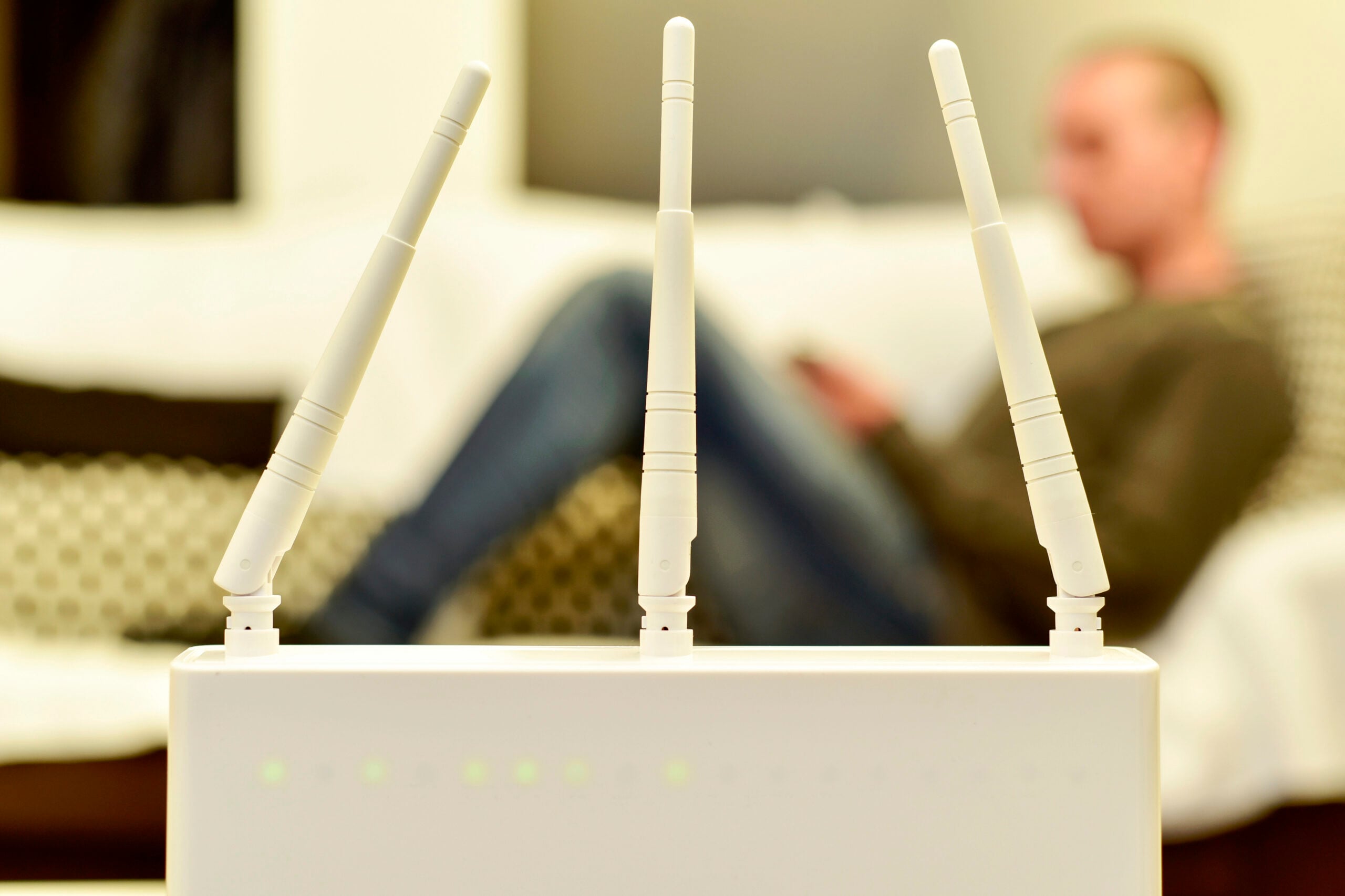 wireless router and young man using a smartphone